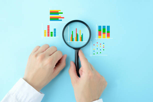 Business man's hand with magnifying glass and various business graphs on light blue background Business man's hand with magnifying glass and various business graphs on light blue background Market Research stock pictures, royalty-free photos & images