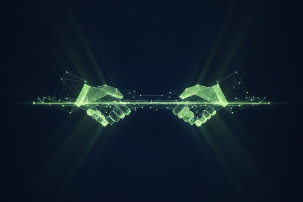 Abstract glowing handshake representing offshore development partnership